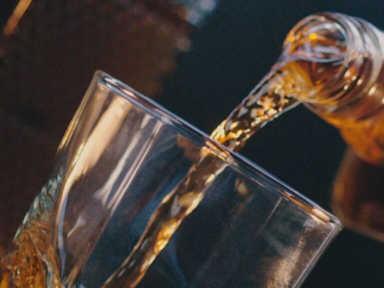 osoba sipa rakiju u čašu